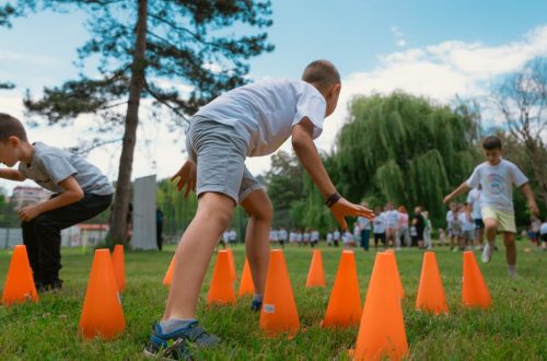 Group of kids enjoying exercise and play at a park obstacle course.