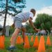 Group of kids enjoying exercise and play at a park obstacle course.